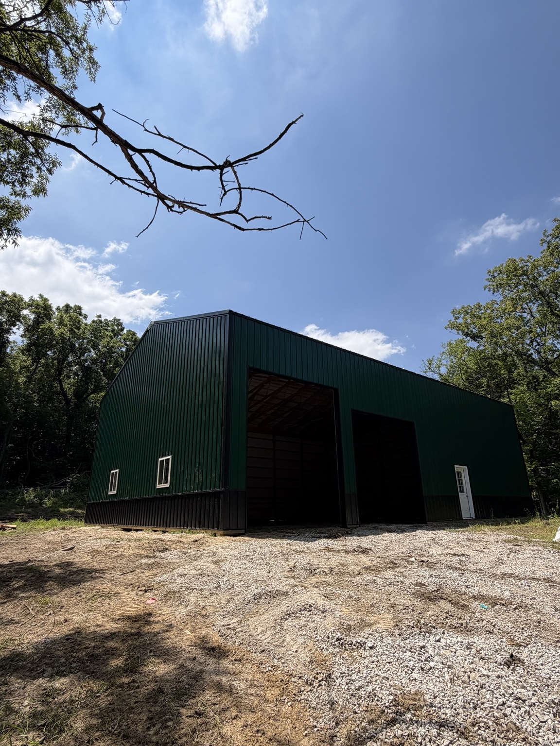 Green and black metal pole barn